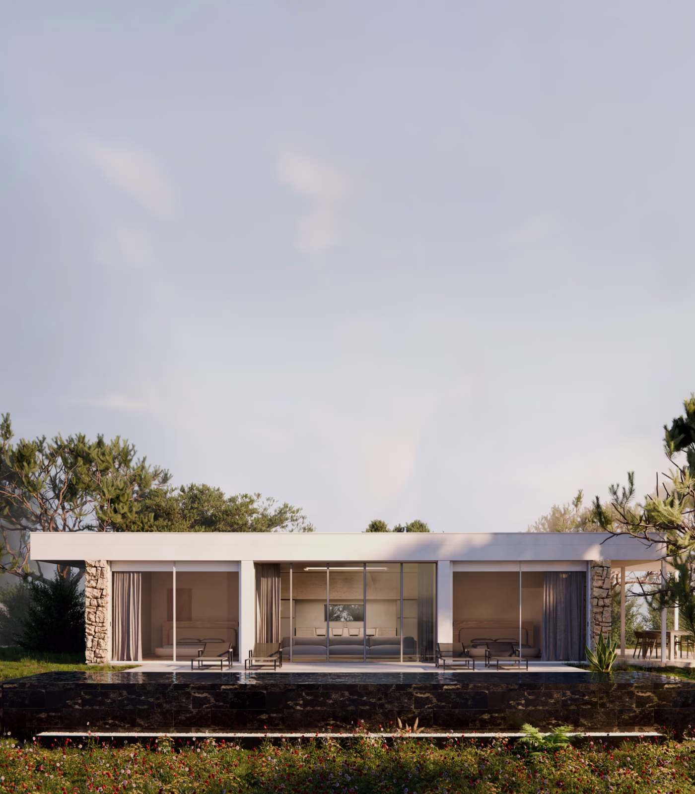 Villa contemporanea a un piano al tramonto, con fronte vetrato continuo e basamento in pietra.